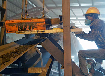 Permanent Magnetic Separator with manual cleaning tray. Here you see an operator cleaning the collected ferrous scrap.