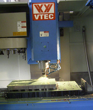 THrough Drilling operation on a VMC.<BR><u>Note</u>: the job is raised above the chuck using pole extensions, so that the through drill does not damage the Electro Permanent Magnetic chuck.